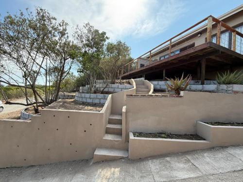 a house with stairs leading up to a building at Seenekal views in Cannon Rocks
