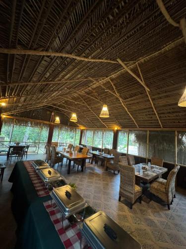 a restaurant with tables and chairs in a room at Pine Ridge Lodge Belize in San Ignacio