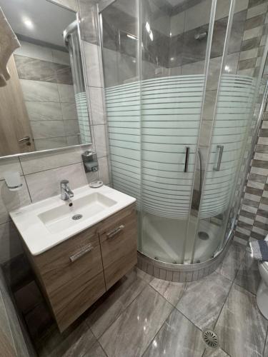 a bathroom with a sink and a shower at Mihalis Studios in Karpathos