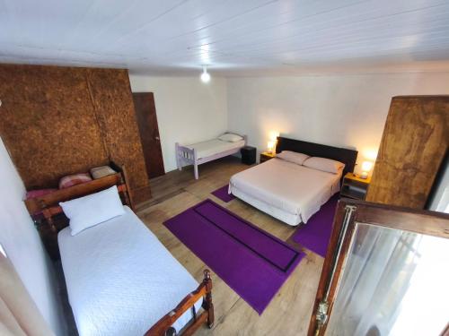 an overhead view of a bedroom with two beds and purple mats at Luz del Alba in Durazno