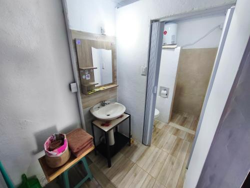 a small bathroom with a sink and a mirror at Luz del Alba in Durazno