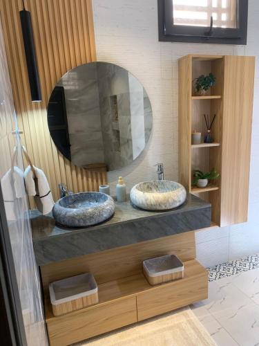 two sinks in a bathroom with a large mirror at La villa Bella Vista in Somone