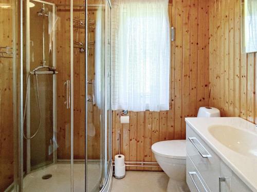 a bathroom with a shower and a toilet and a sink at 4 person holiday home in BENGTSFORS in Bengtsfors