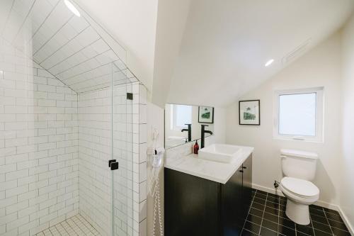 a white bathroom with a sink and a toilet at Noon on Sunset Hill in Los Angeles