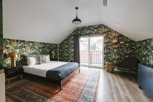 a bedroom with a bed and floral wallpaper at Noon on Sunset Hill in Los Angeles