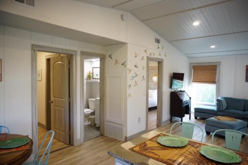 a living room with a table and a living room at Anna Maria Island Tree House Pet Friendly! in Bradenton Beach
