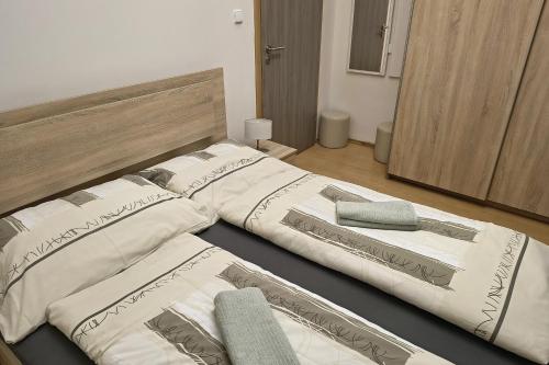two beds sitting next to each other in a room at Relax apartmá Brno central - Brno střed in Brno