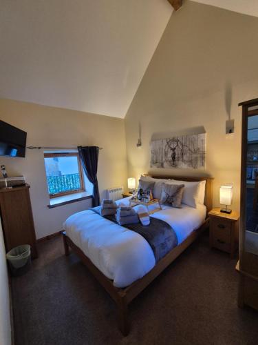a bedroom with a large bed and a window at The Old Post House in Fort William