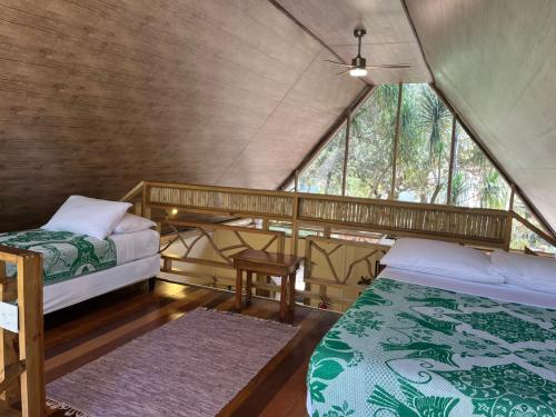 a bedroom with two beds in a tent at Pine Ridge Lodge Belize in San Ignacio