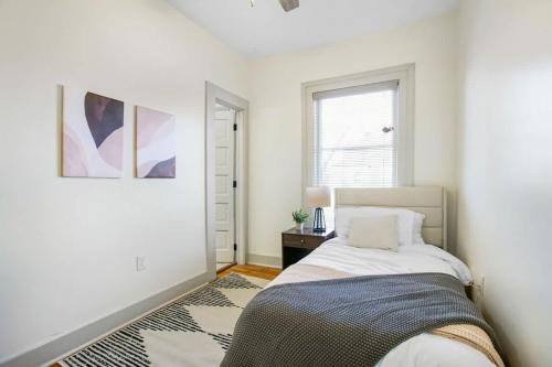 a bedroom with a bed and a window at Victorian Cozy Retreat Steps to Cleveland Clinic in Cleveland