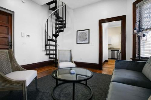 a living room with a couch and a glass table at Victorian Cozy Retreat Steps to Cleveland Clinic in Cleveland