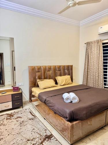 a bedroom with a bed with two towels on it at Dar E Noor in Hyderabad