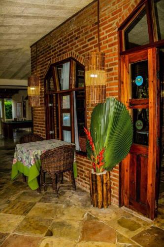a dining room with a table and a plant at La Dolce Vita in Mulungu