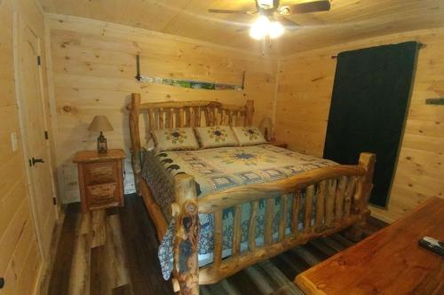 a bedroom with a wooden bed in a cabin at Country Bumpkin Cabin in Banner Elk