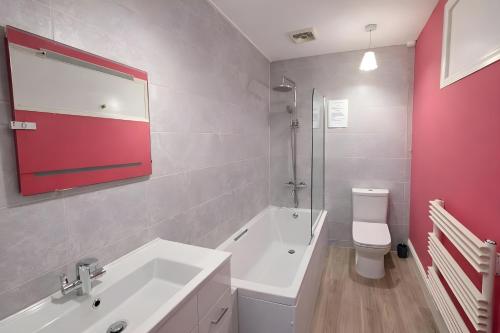 a bathroom with a white sink and a toilet at Dog Friendly Lakeland Apartment - Private Parking - Central Location in Cockermouth