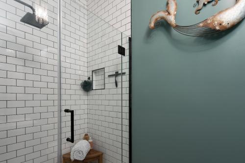 a bathroom with a shower with a seahorse on the wall at The Alibi- We will cover for you in Port Clinton