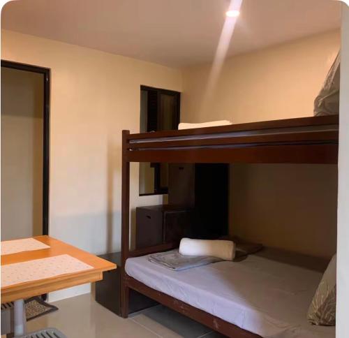 two bunk beds in a room with a desk at Studio Apartment in Mactan,Cebu Room203 in Lapu Lapu City