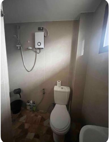 a bathroom with a toilet and a shower at Studio Apartment in Mactan,Cebu Room203 in Lapu Lapu City