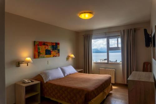 a hotel room with a bed and a window at Patagonia Sur Hotel in San Carlos de Bariloche