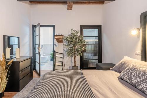 a bedroom with a bed and a desk and a bathroom at The Townhouse Barga in Barga