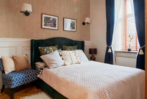 a bedroom with a bed and a chair at Luxury OldTown Free Parking in Vilnius