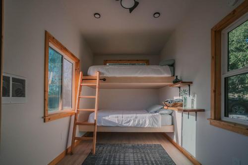 a room with two bunk beds and a window at Off-Grid Tiny Home Pacific Views & Serenity in Pauma Valley