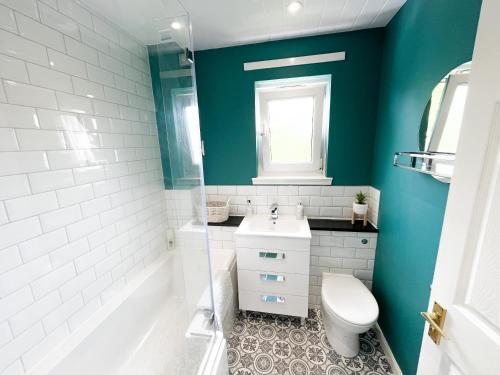 a bathroom with a white toilet and a sink at Inverness Holiday Retreat - 2 Bedroom in Inverness