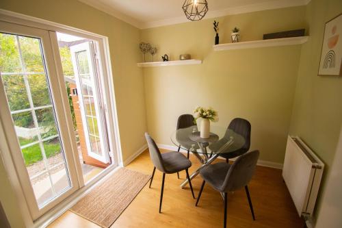 a dining room with a table and chairs and a window at Inverness Holiday Retreat - 2 Bedroom in Inverness