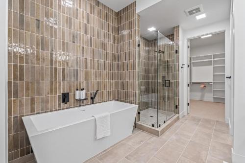 a bathroom with a tub and a shower at Serengeti Suite in Downtown Eagle in Eagle