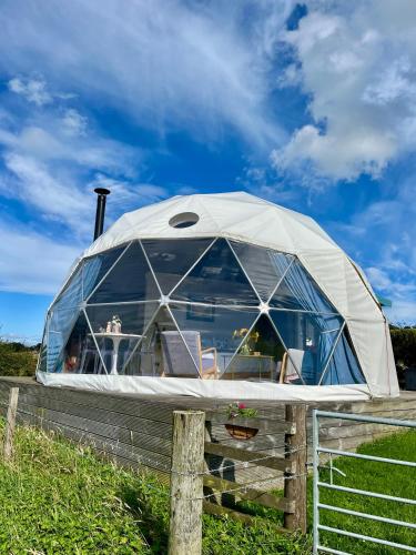 a dome tent on a fence in a field at The Dome at Midauchengowan in Lochwinnoch