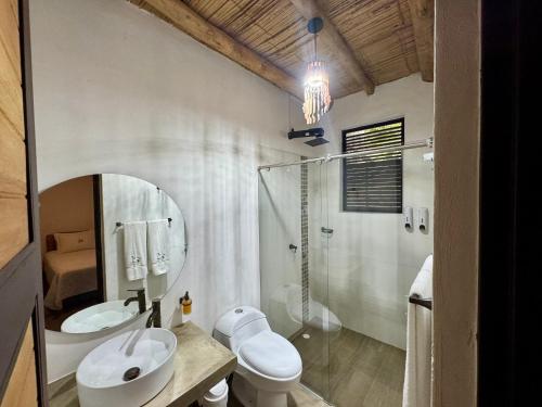 a bathroom with a sink and a toilet and a shower at Finca Campestre Colibrí in Quebradanegra