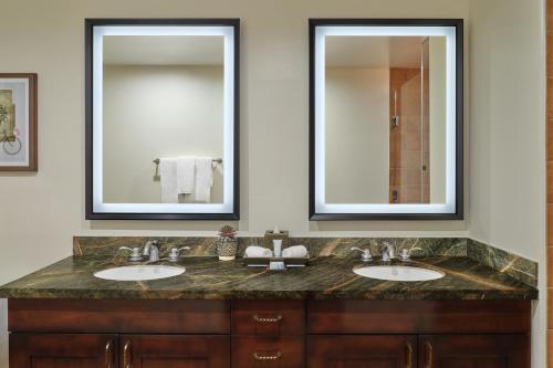 a bathroom with two sinks and two mirrors at Hyatt Vacation Club at Pinon Pointe, Sedona in Sedona