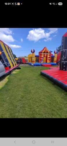 a large playground with colorful slides and grass at S&l caravan holidays in Winthorpe