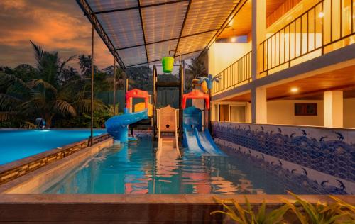 a swimming pool with a slide in a resort at Talpe Paradise in Galle