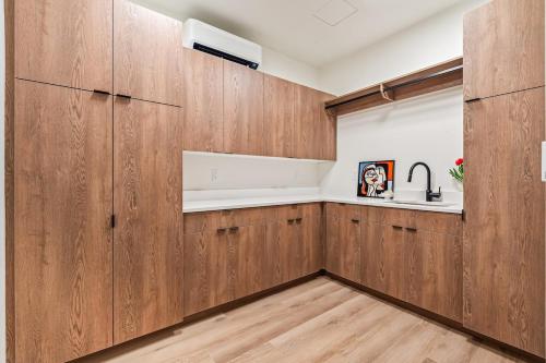 a kitchen with wooden cabinets and a sink at Emerald City in Downtown Eagle in Eagle