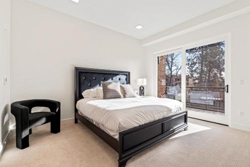 a bedroom with a bed and a chair and a window at Emerald City in Downtown Eagle in Eagle