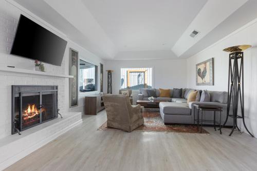 a living room with a couch and a fireplace at Guadalupe Bluff Farmhouse in Kerrville