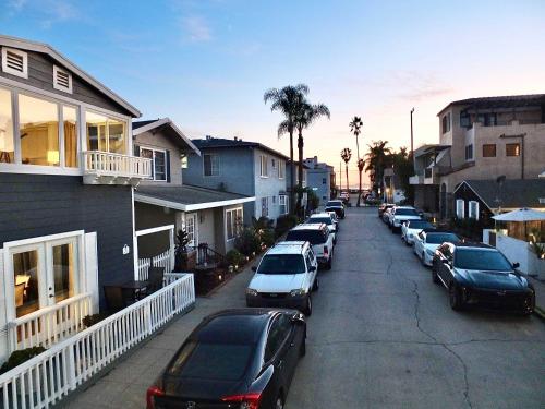 a row of cars parked in a parking lot at LB Peninsula Steps to Beach close to in Long Beach