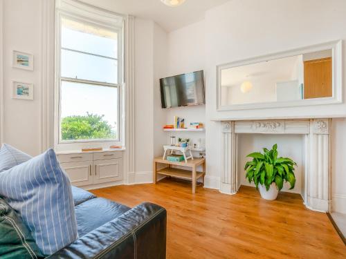 a living room with a couch and a fireplace at The Beach Studio in Brighton & Hove