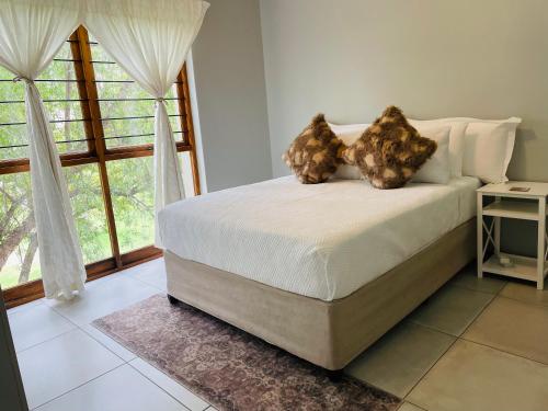 a bedroom with a bed with two teddy bears on it at Villa by The Vaal River in Vanderbijlpark