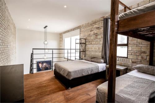 a bedroom with two beds and a fireplace at Bungalows in Samsara Atlixco in La Sabana