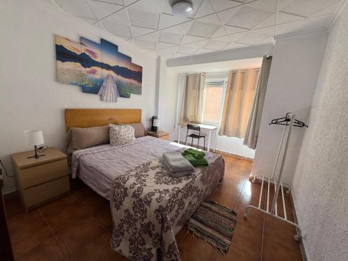 a bedroom with a bed and a table in it at Albalat Centro in Albalat de la Ribera