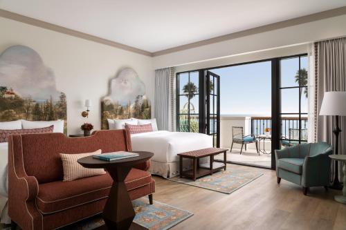 a hotel room with a bed and a couch at La Bahia Hotel & Spa in Santa Cruz