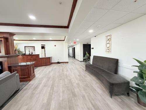 an office lobby with a couch and a desk at Black Gold Suites Stanley in Stanley