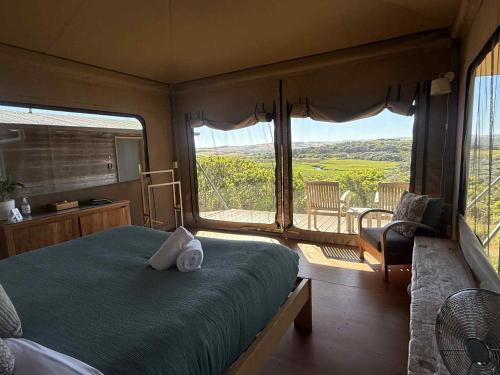 a bedroom with a bed and a window with a view at Pebble Point in Princetown