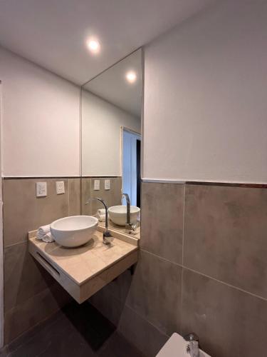 a bathroom with two sinks and a large mirror at Boho Suites in Tafí del Valle