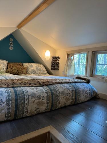 a bedroom with a large bed in a attic at Magnolia Petal Accommodation in Salt Spring Island