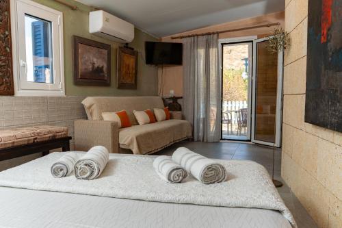 a living room with a bed with pillows on it at Villa Art Natalie in Kithnos