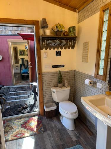 a bathroom with a toilet and a tub and a sink at Magnolia Petal Accommodation in Salt Spring Island