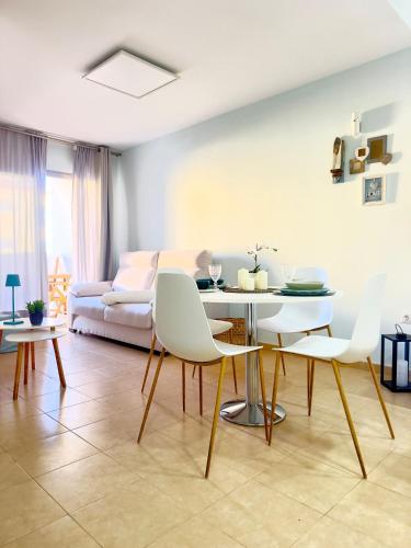 a living room with a table and white chairs at NextGen Dimora Luna I Private Garden & Pool Fuerteventura in Costa de Antigua
